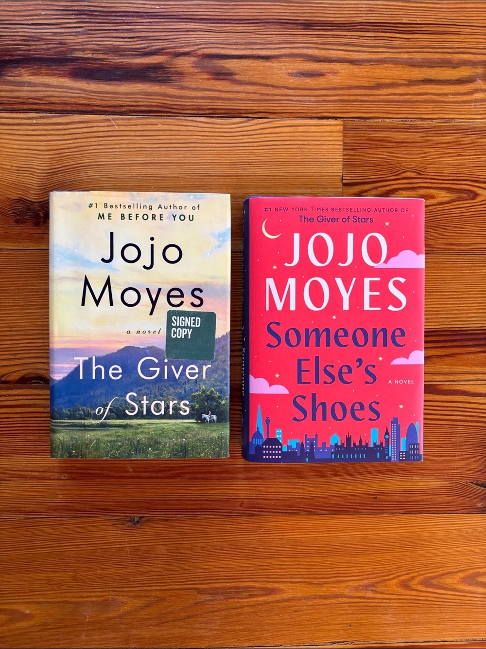 2 Hardcover Books By Jojo Moyes…Someone Else’s Shoes And The Giver Of Stars